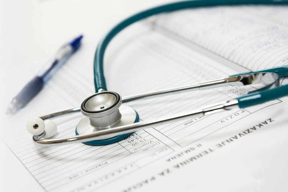 Stethoscope on a blue surface representing health insurance